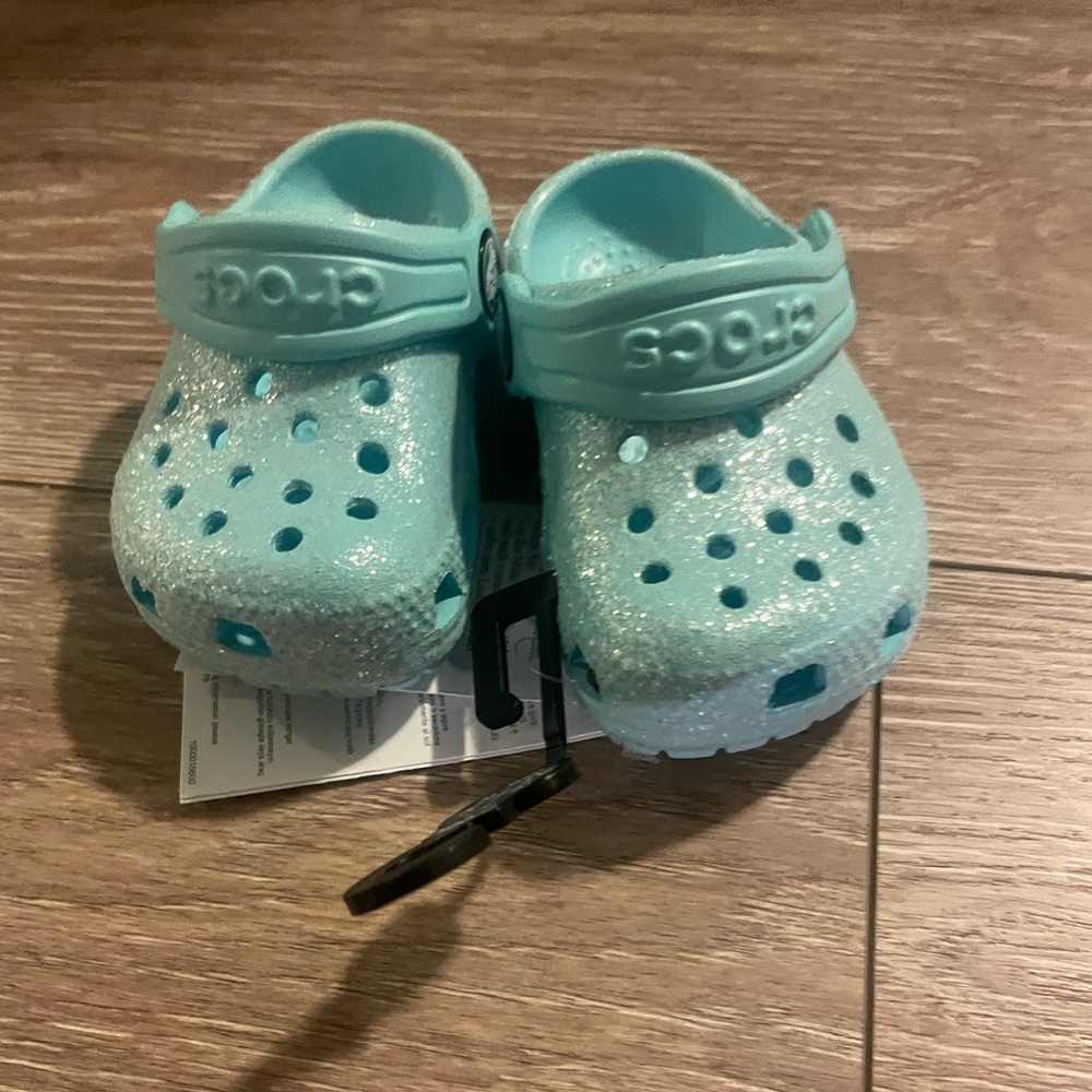 Blue sparkly baby crocs